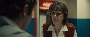 Movie still from “Extremely Wicked, Shockingly Evil and Vile” (2019), directed by Joe Berlinger – A woman wearing glasses and a red sweater; Close Up shot, Over the shoulder angle