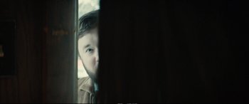 Movie still from “Extremely Wicked, Shockingly Evil and Vile” (2019), directed by Joe Berlinger – A man with a goatee looking out of a window; Close Up shot, Over the shoulder angle