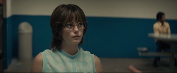 Movie still from “Extremely Wicked, Shockingly Evil and Vile” (2019), directed by Joe Berlinger – A woman wearing glasses and looking to her left; Close Up shot, Over the shoulder angle