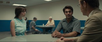 Movie still from “Extremely Wicked, Shockingly Evil and Vile” (2019), directed by Joe Berlinger – A group of men sitting at a table in a room; Medium shot, Over the shoulder angle