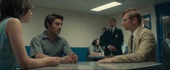 Movie still from “Extremely Wicked, Shockingly Evil and Vile” (2019), directed by Joe Berlinger – A group of men sitting at a table in a room; Medium shot, Over the shoulder angle
