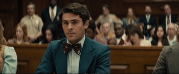 Movie still from “Extremely Wicked, Shockingly Evil and Vile” (2019), directed by Joe Berlinger – A man sitting in front of a group of people in a court room; Close Up shot, Over the shoulder angle