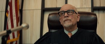 Movie still from “Extremely Wicked, Shockingly Evil and Vile” (2019), directed by Joe Berlinger – An older man sitting in a judge's chair in a courtroom; Close Up shot, Over the shoulder angle