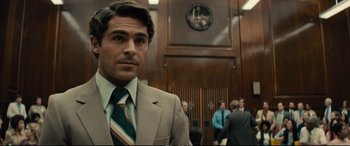 Movie still from “Extremely Wicked, Shockingly Evil and Vile” (2019), directed by Joe Berlinger – A man in a suit and tie in a court room; Close Up shot, Over the shoulder angle