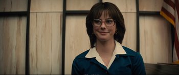 Movie still from “Extremely Wicked, Shockingly Evil and Vile” (2019), directed by Joe Berlinger – A woman wearing glasses standing in front of a wall; Close Up shot, Low angle
