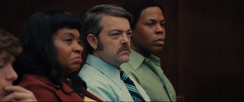 Movie still from “Extremely Wicked, Shockingly Evil and Vile” (2019), directed by Joe Berlinger – A man with a mustache sitting next to two other men; Close Up shot, Over the shoulder angle