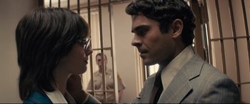 Movie still from “Extremely Wicked, Shockingly Evil and Vile” (2019), directed by Joe Berlinger – A man and a woman in front of a jail cell; Close Up shot, Over the shoulder angle