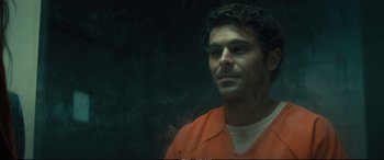 Movie still from “Extremely Wicked, Shockingly Evil and Vile” (2019), directed by Joe Berlinger – A man in an orange prison uniform looking at the camera; Close Up shot, Over the shoulder angle