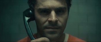 Movie still from “Extremely Wicked, Shockingly Evil and Vile” (2019), directed by Joe Berlinger – A person holding a cell phone; Close Up shot, Overhead angle