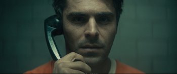Movie still from “Extremely Wicked, Shockingly Evil and Vile” (2019), directed by Joe Berlinger – A person holding a wrench; Extreme Close Up shot, Overhead angle