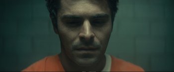 Movie still from “Extremely Wicked, Shockingly Evil and Vile” (2019), directed by Joe Berlinger – A person wearing an orange shirt; Close Up shot, Overhead angle