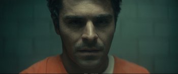 Movie still from “Extremely Wicked, Shockingly Evil and Vile” (2019), directed by Joe Berlinger – A person wearing an orange shirt; Extreme Close Up shot, Overhead angle