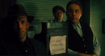 Movie still from “Matewan” (1987), directed by John Sayles – A group of men standing next to each other in a room; Close Up shot, Low angle