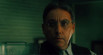 Movie still from “Matewan” (1987), directed by John Sayles – A person wearing a suit and glasses; Close Up shot, Low angle