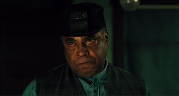 Movie still from “Matewan” (1987), directed by John Sayles – An older man wearing a hat and a suit; Close Up shot, Low angle