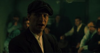 Movie still from “Matewan” (1987), directed by John Sayles – A man wearing a hat and a suit; Close Up shot, Low angle