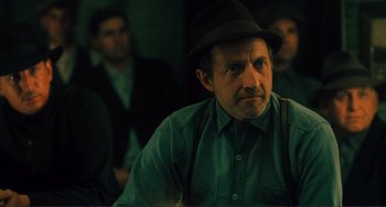 Movie still from “Matewan” (1987), directed by John Sayles – An old man wearing a hat is looking at the camera; Close Up shot, Over the shoulder angle