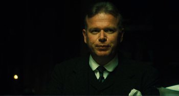 Movie still from “Matewan” (1987), directed by John Sayles – A person wearing a suit and tie; Close Up shot, Over the shoulder angle