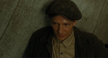 Movie still from “Matewan” (1987), directed by John Sayles – A man wearing a hat and a brown jacket; Close Up shot, High angle