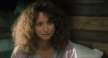 Movie still from “Matewan” (1987), directed by John Sayles – A woman with curly brown hair sitting on a bed; Close Up shot, High angle