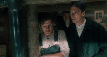 Movie still from “Matewan” (1987), directed by John Sayles – A man in overalls is looking down at his face; Medium shot, Low angle