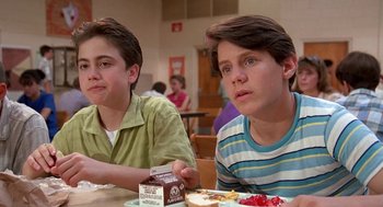 Movie still from “Matinee” (1993), directed by Joe Dante – Two young men sitting at a table with food; Close Up shot, Low angle