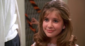 Movie still from “Matinee” (1993), directed by Joe Dante – A young girl with long brown hair and blue eyes; Close Up shot, Over the shoulder angle