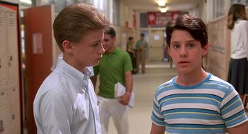 Movie still from “Matinee” (1993), directed by Joe Dante – Two young men standing next to each other in a hallway; Close Up shot, Low angle