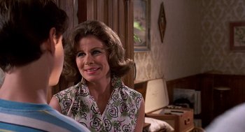 Movie still from “Matinee” (1993), directed by Joe Dante – An older woman is smiling at a young man; Close Up shot, Over the shoulder angle