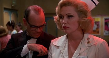 Movie still from “Matinee” (1993), directed by Joe Dante – A man and a woman are looking at one another; Close Up shot, Over the shoulder angle