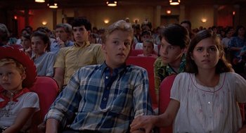 Movie still from “Matinee” (1993), directed by Joe Dante – A group of young people sitting in a theater; Medium shot, High angle