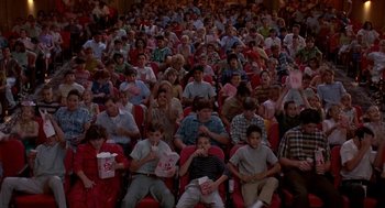Movie still from “Matinee” (1993), directed by Joe Dante – A large group of people sitting in a theater; Wide shot, High angle