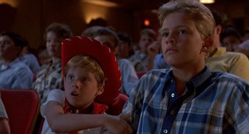 Movie still from “Matinee” (1993), directed by Joe Dante – A boy wearing a red cowboy hat and a boy wearing a blue plaid shirt; Close Up shot, Low angle