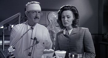 Movie still from “Matinee” (1993), directed by Joe Dante – An old photo of a man and a woman with bandages on; Medium shot, Low angle