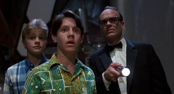 Movie still from “Matinee” (1993), directed by Joe Dante – A group of people standing next to each other in a room; Medium shot, Low angle