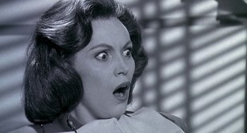 Movie still from “Matinee” (1993), directed by Joe Dante – An old photo of a woman with a surprised look on her face; Close Up shot, Low angle