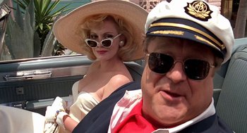Movie still from “Matinee” (1993), directed by Joe Dante – A man and a woman sitting in the back of a car; Close Up shot, Low angle