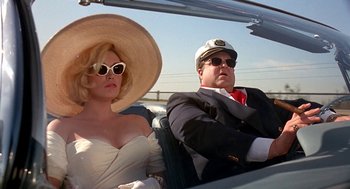 Movie still from “Matinee” (1993), directed by Joe Dante – A man and a woman sitting in the back of a car; Medium shot, Low angle