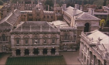 Movie still from “Maurice” (1987), directed by James Ivory – An aerial view of an old building in a city; Extreme Wide shot, High angle