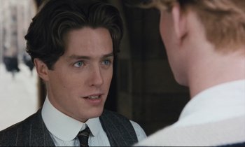 Movie still from “Maurice” (1987), directed by James Ivory – A man in a suit and tie looking into a mirror; Close Up shot, Over the shoulder angle