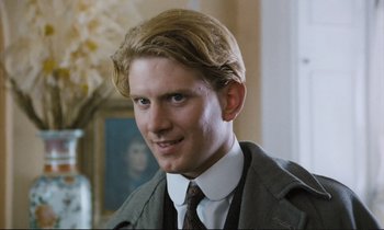 Movie still from “Maurice” (1987), directed by James Ivory – A man with blonde hair wearing a suit and tie; Close Up shot, Low angle