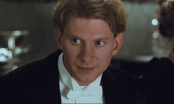 Movie still from “Maurice” (1987), directed by James Ivory – A person wearing a tuxedo; Close Up shot, High angle