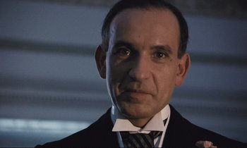 Movie still from “Maurice” (1987), directed by James Ivory – A person wearing a suit and tie; Close Up shot, Low angle
