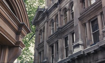 Movie still from “Maurice” (1987), directed by James Ivory – A large building with many windows on the side of the building; Extreme Wide shot, Low angle