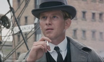 Movie still from “Maurice” (1987), directed by James Ivory – A man in a suit and tie holding a cell phone; Close Up shot, Low angle