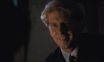 Movie still from “Maurice” (1987), directed by James Ivory – A man with blonde hair wearing a suit and tie; Close Up shot, Low angle