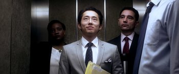 Movie still from “Mayhem” (2017), directed by Joe Lynch – A man in a suit and tie standing in an elevator; Medium shot, Low angle