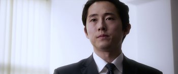 Movie still from “Mayhem” (2017), directed by Joe Lynch – A person wearing a suit and tie; Close Up shot, Low angle