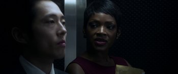 Movie still from “Mayhem” (2017), directed by Joe Lynch – A woman and a man are standing in an elevator; Close Up shot, Over the shoulder angle