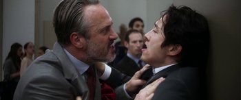 Movie still from “Mayhem” (2017), directed by Joe Lynch – Two men in business suits fighting in an office; Close Up shot, Over the shoulder angle